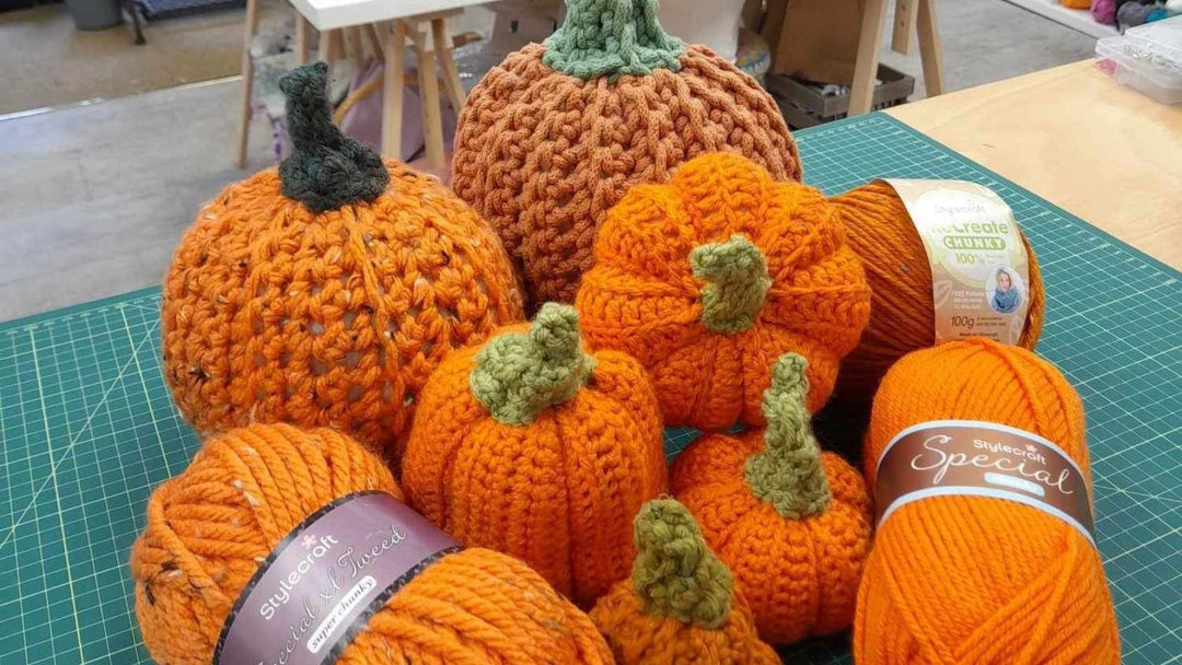 how to crochet a pumpkin items including balls of yarn and finished pumpkins
