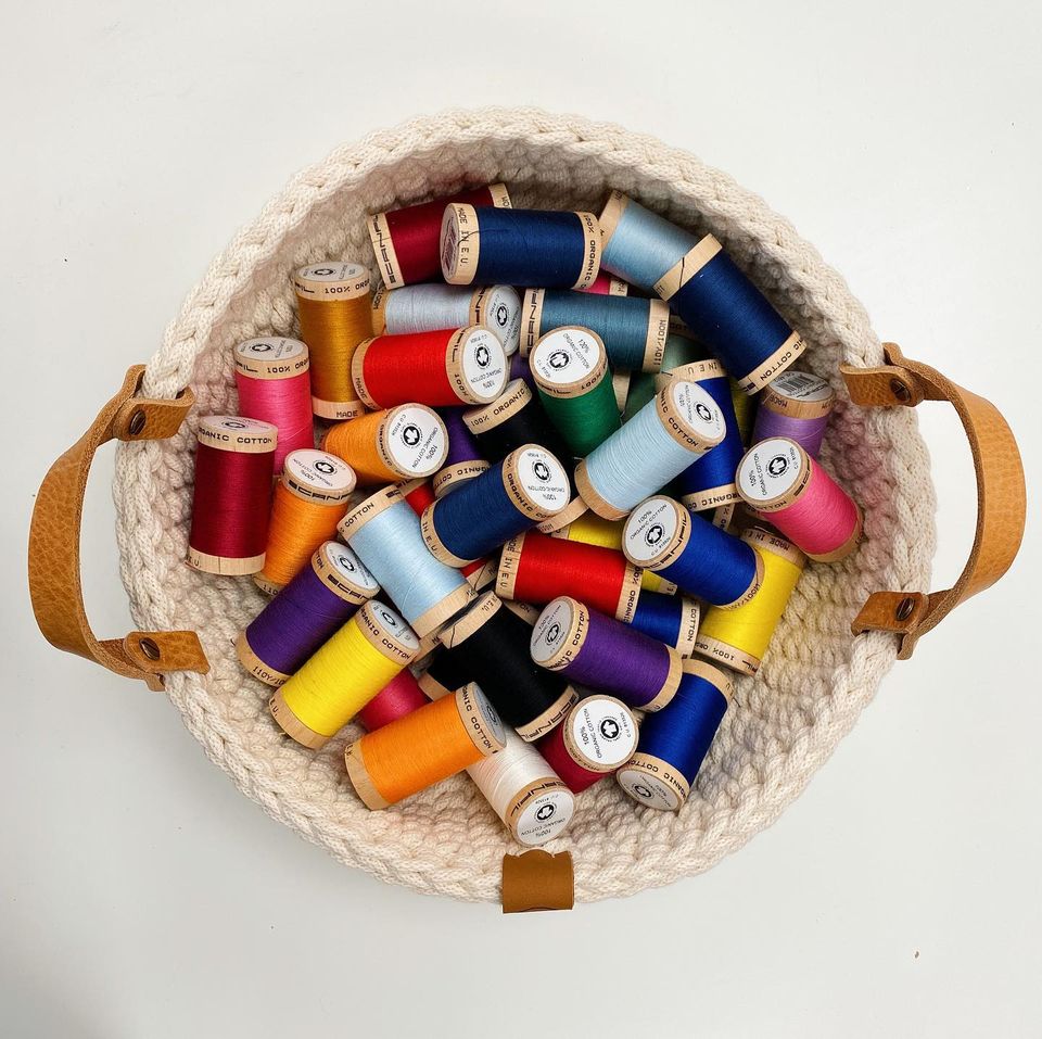 A basket full of sewing thread